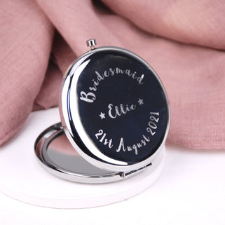 Bridesmaid Compact Mirror with "Ellie" engraved in the centre, "Bridesmaid" engraved at the top and "21st August 2021" engraved across the bottom shown in close up shot