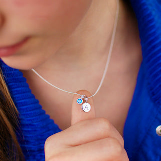 Sterling Silver Personalised A Initial and December Blue Topaz Birthstone Necklace shown close up on model