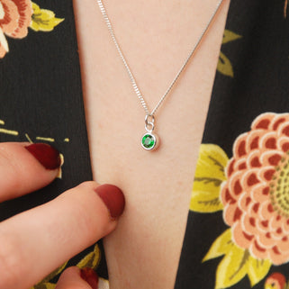 Sterling Silver Mini Emerald/May Birthstone Charm Necklace shown close up on model