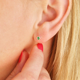 Tiny Sterling Silver May/Emerald Birthstone Stud Earrings shown on close up of model