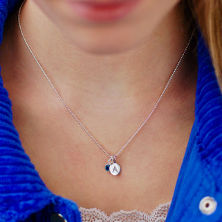 Sterling Silver Personalised A Initial Disc and September Sapphire Birthstone Necklace shown on model close up
