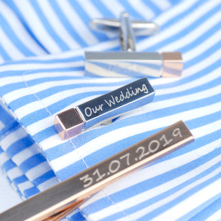 close up shot of silver cufflink with rose gold tip with "our wedding" engraving.