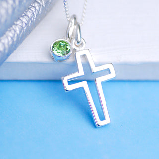 Silver cross charm necklace with August/Peridot birthstone charm, shown in close up shot