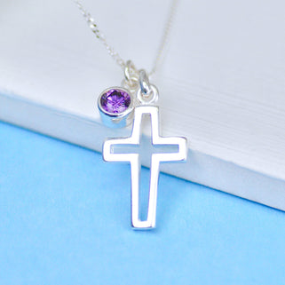 Silver cross charm necklace with February/Amethyst birthstone charm, shown in close up shot