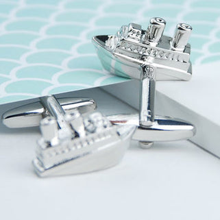 Cruise Ship Cufflinks shown in close up shot on blue background