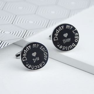 Personalised daddy my hero cufflinks with "Billy heart, Daddy my lego builder" engraved on one and "Iris heart, Daddy my spider catcher" engraved on the other shown in close up shot