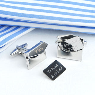 Personalised love letters cufflinks with "P&S" engraved on the front of envelope and "To have & to hold" & "23rd July 2019" engraved on the letters, shown in close up shot.