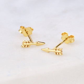 Pair of Tiny Gold Vermeil Arrow Stud Earrings shown in close up shot