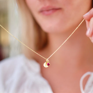 Gold Vermeil Mini Initial E and July/Ruby Birthstone Necklace shown held by model 