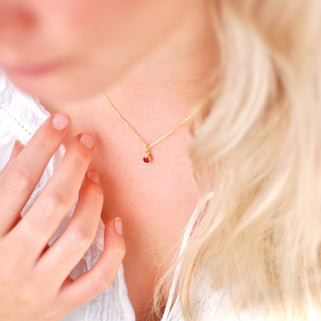 Gold Vermeil Mini Blue Ruby/July Birthstone Charm Necklace shown on model close up
