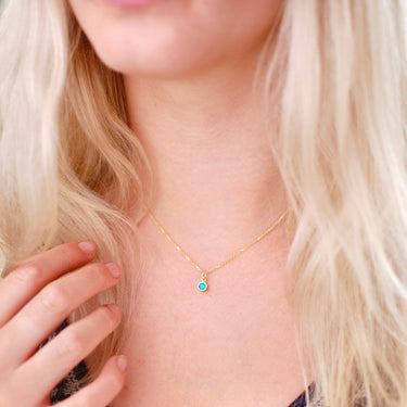 Gold Vermeil Mini Blue Topaz/December Birthstone Charm Necklace shown on model close up