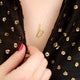 gold vermeil floating feather necklace shown in close up shot on model