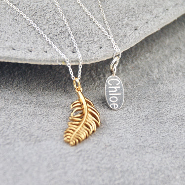 Gold vermeil floating feather necklace with silver oval disc on the back clasp with 