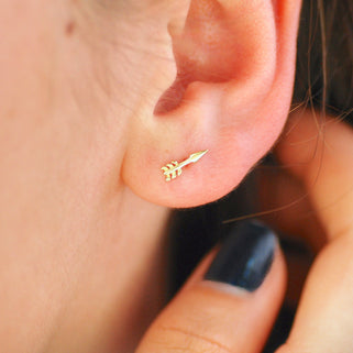 Tiny Sterling Silver Gold Vermeil Arrow Stud Earrings shown on close up of model