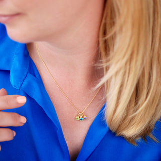 Personalised Gold Family Birthstone Necklace with three birthstones - August/Peridot, December/Blue Topaz, February/Amethyst shown on model close up