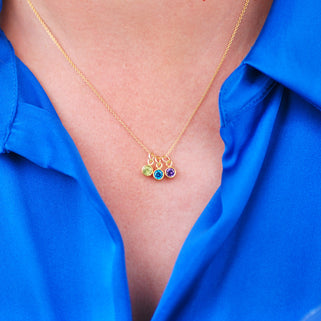 Personalised Gold Family Birthstone Necklace with three birthstones - August/Peridot, December/Blue Topaz, February/Amethyst shown on model