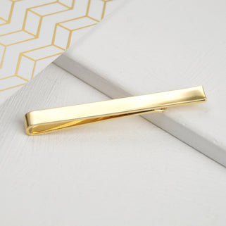 Gold tie slide shown in close up shot.
