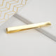 Gold tie slide shown in close up shot.