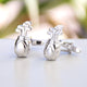 Silver golf club cufflinks shown in close up shot