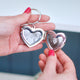 Silver heart locket keyring with two images inside shown with model.