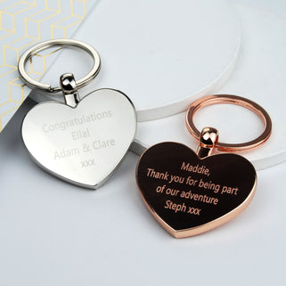 Silver heart keyring with "Congratulations Ella! Adam & Clare xxx" engraved on the front and rose gold heart keying with "Maddie Thank you for being part of our adventure Steph xxx" 