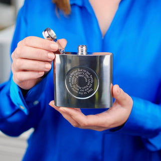 Silver hip flask with engraved spiral message on the front