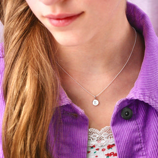 Sterling Silver E Initial Disc Necklace shown close up on model