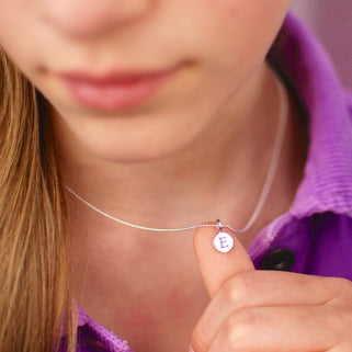 Sterling Silver E Initial Disc Necklace show close up on model