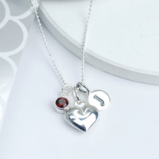 Sterling Silver Heart Necklace with J Initial disc and Ruby July birthstone shown close up