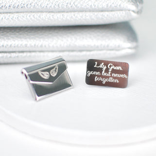 Personalised Angel Wing Hidden Message Memorial Pin with "Lily Gran, gone but never forgotten" engraved on letter