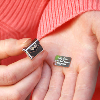 Personalised Angel Wing Hidden Message Memorial Pin with "Lily Gran, gone but never forgotten" engraved on letter