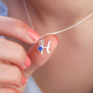 Sterling Silver Script Initial "H" and September/Sapphire Birthstone Necklace shown in close up shot on model