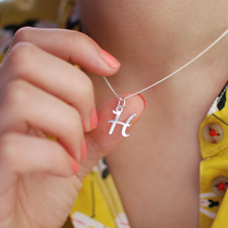 Sterling Silver Script Initial "H" Necklace shown on close up on model