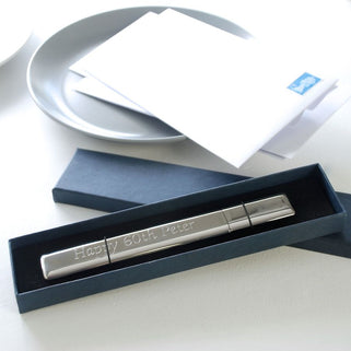 Silver letter opener with Happy 60th Peter engraved on the front, shown in box packaging.