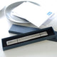 Silver letter opener with Happy 60th Peter engraved on the front, shown in box packaging.