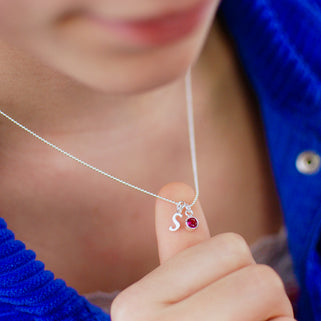 Sterling Silver Script Initial S and July Ruby Birthstone Necklace shown on model close up
