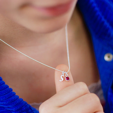 Sterling Silver Script Initial S and July Ruby Birthstone Necklace shown on model close up