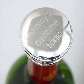 Wine stopper with "Mummy's bedtime tonic" engraved on the top, shown in close up shot on bottle.