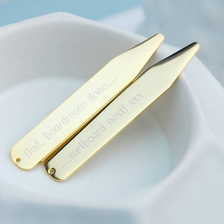 Gold collar stiffeners with "Dad, boardroom done..." engraved on one and "...surfboard next! xxx" engraved on the other, shown in close up shot.
