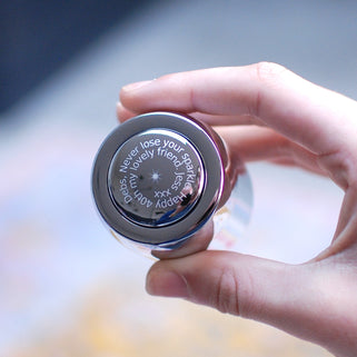 Prosecco stopper with personalised spiral message shown in close up with model