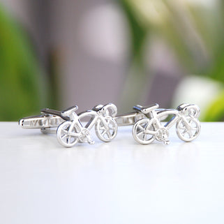 Silver racer bike cufflinks shown in close up shot