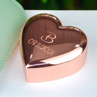 personalised rose gold plated heart trinket box with "B" in the centre and "08.11.2021" engraved underneath, shown in close up shot.