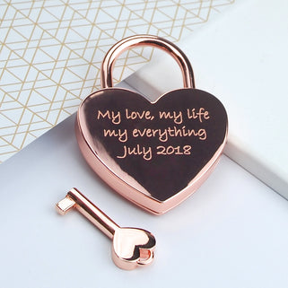 Rose gold lovers padlock and key with "My love, my life my everything July 2018" engraved on the front, shown in close up shot.