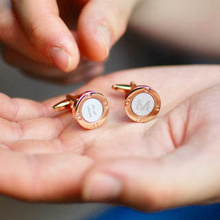 Rose Gold and Silver Coloured Porthole Cufflinks with initial "R" engraved on left cufflink and "M" on right cufflink shown in close up shot with model