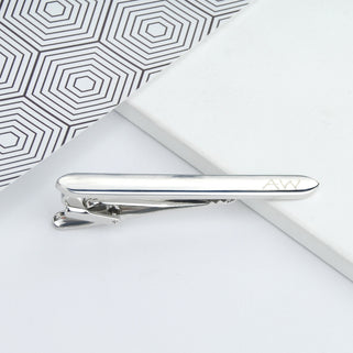 silver tie clip with "AW" engraved the end, shown in close up shot