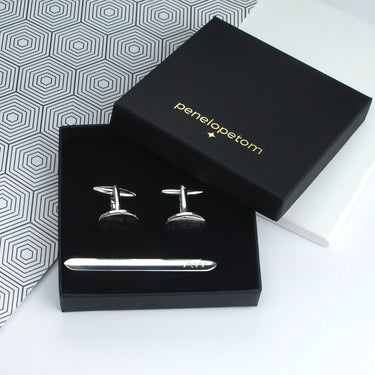 Rounded silver tie clip and oval cufflinks set shown in black Penelopetom box