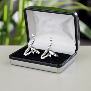 Silver saxophone cufflinks shown in silver chrome rectangle  penelopetom cufflinks box