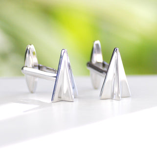 silver paper plane cufflinks shown in close up shot
