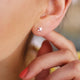 Silver Mini Starfish Studs shown in close up shot on model