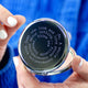 Silver compact mirror with personalised spiral message in typewriter font engraved on the front, shown in close up shot held by model.